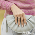 Woman wearing wedding ring holding purse